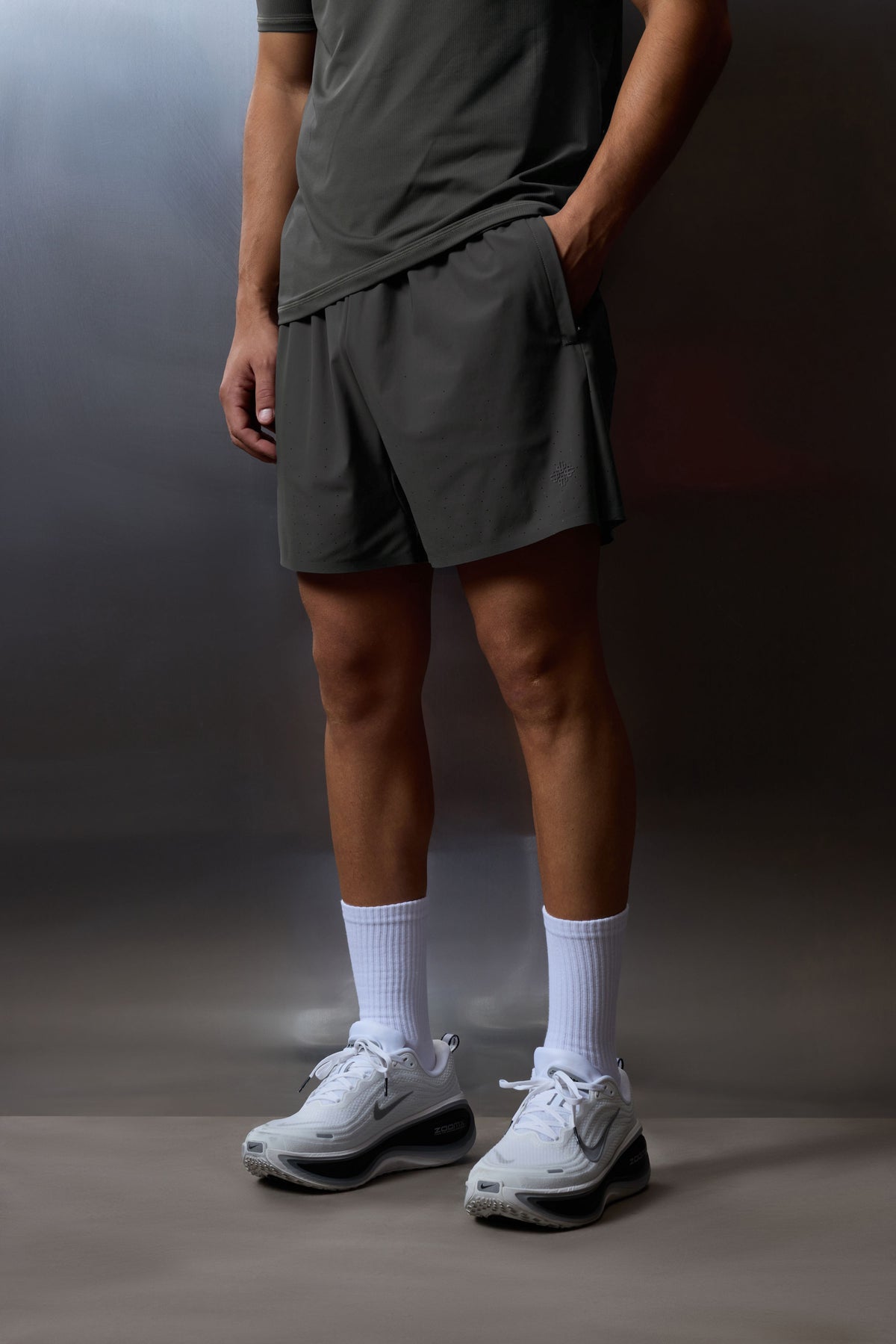Men's Training Short in Charcoal – model cropped front view worn with white socks and trainers