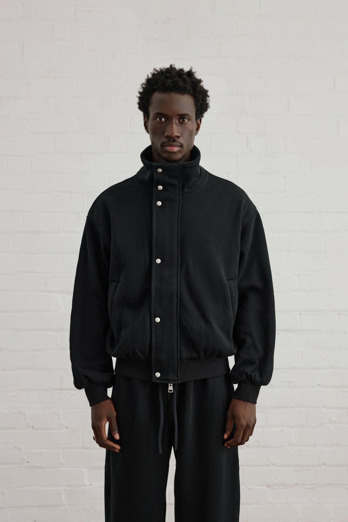 KNIT FLEECEBACK COPYRIGHT FUNNEL NECK - BLACK