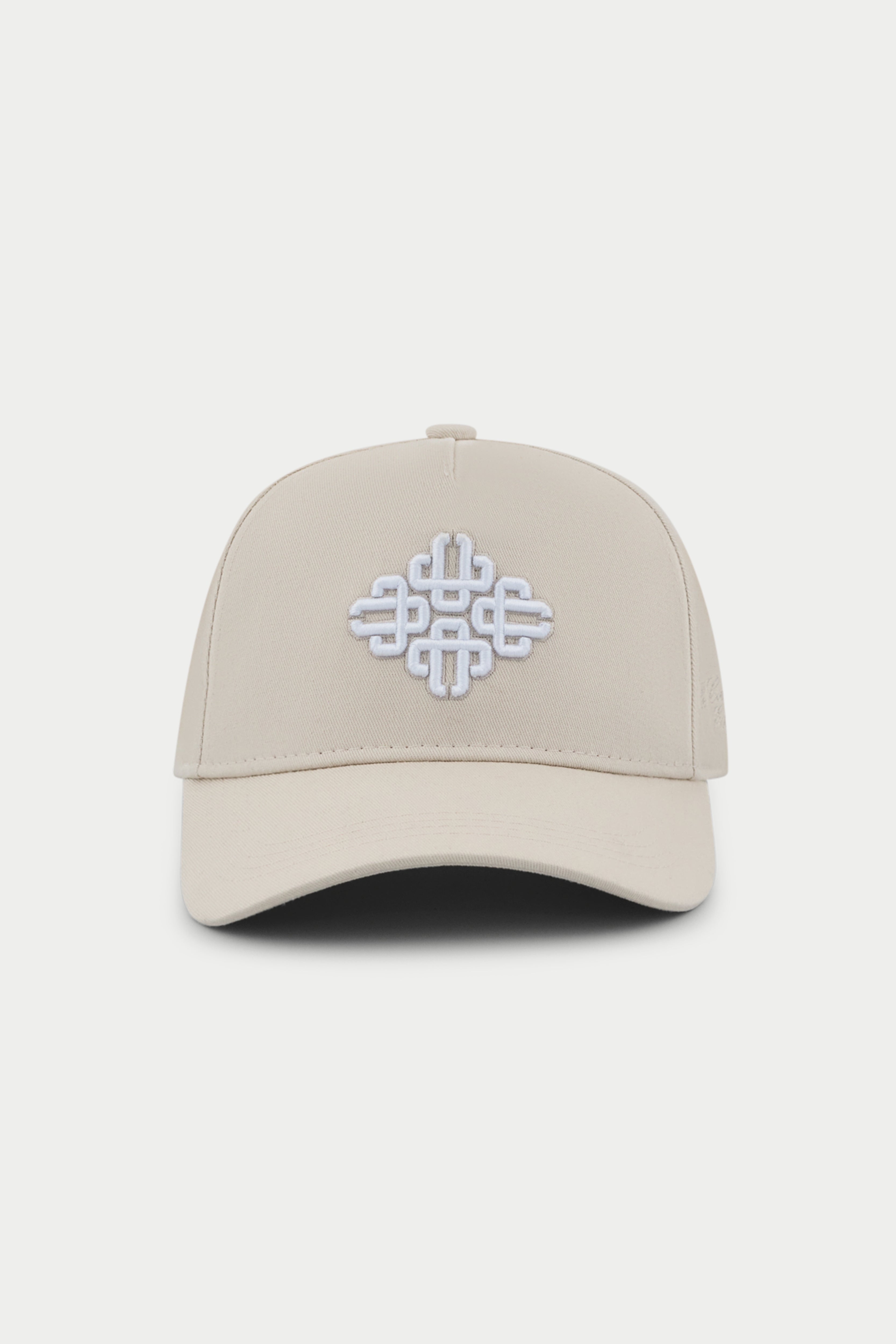 Beige cap with a white embroidered emblem logo on a white background