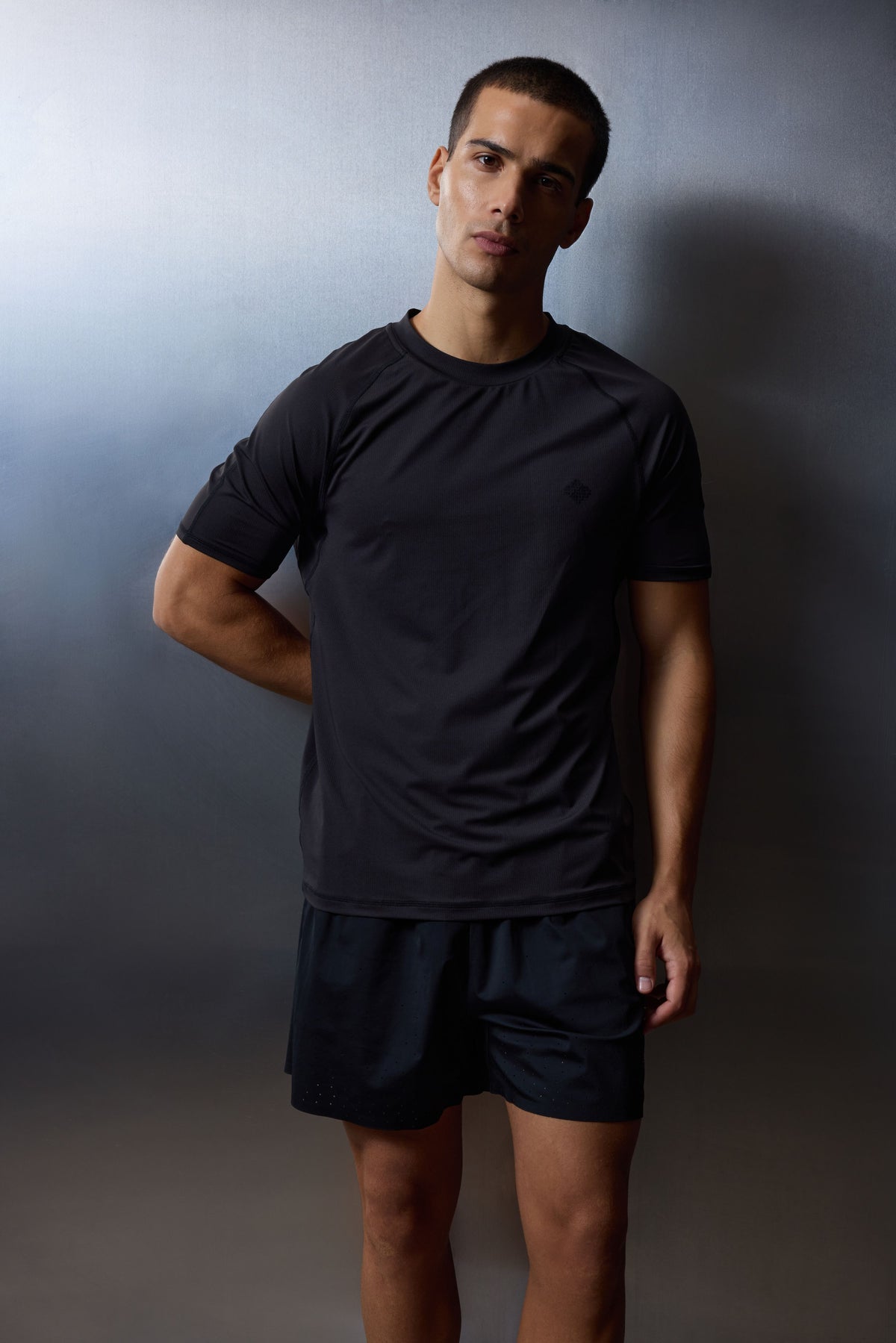 Men's Short Sleeved Training Top in Black – model front view worn with black shorts