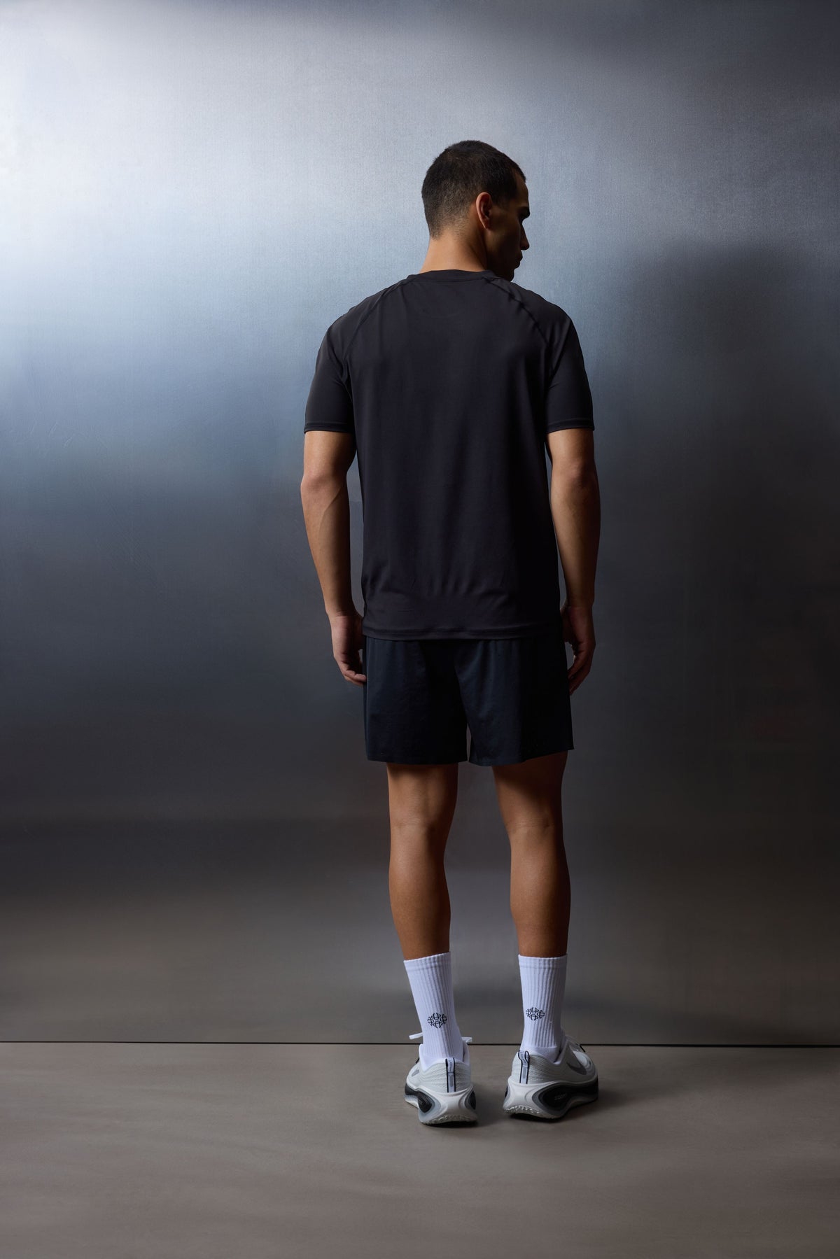 Men's Short Sleeved Training Top in Black – full-length model back view