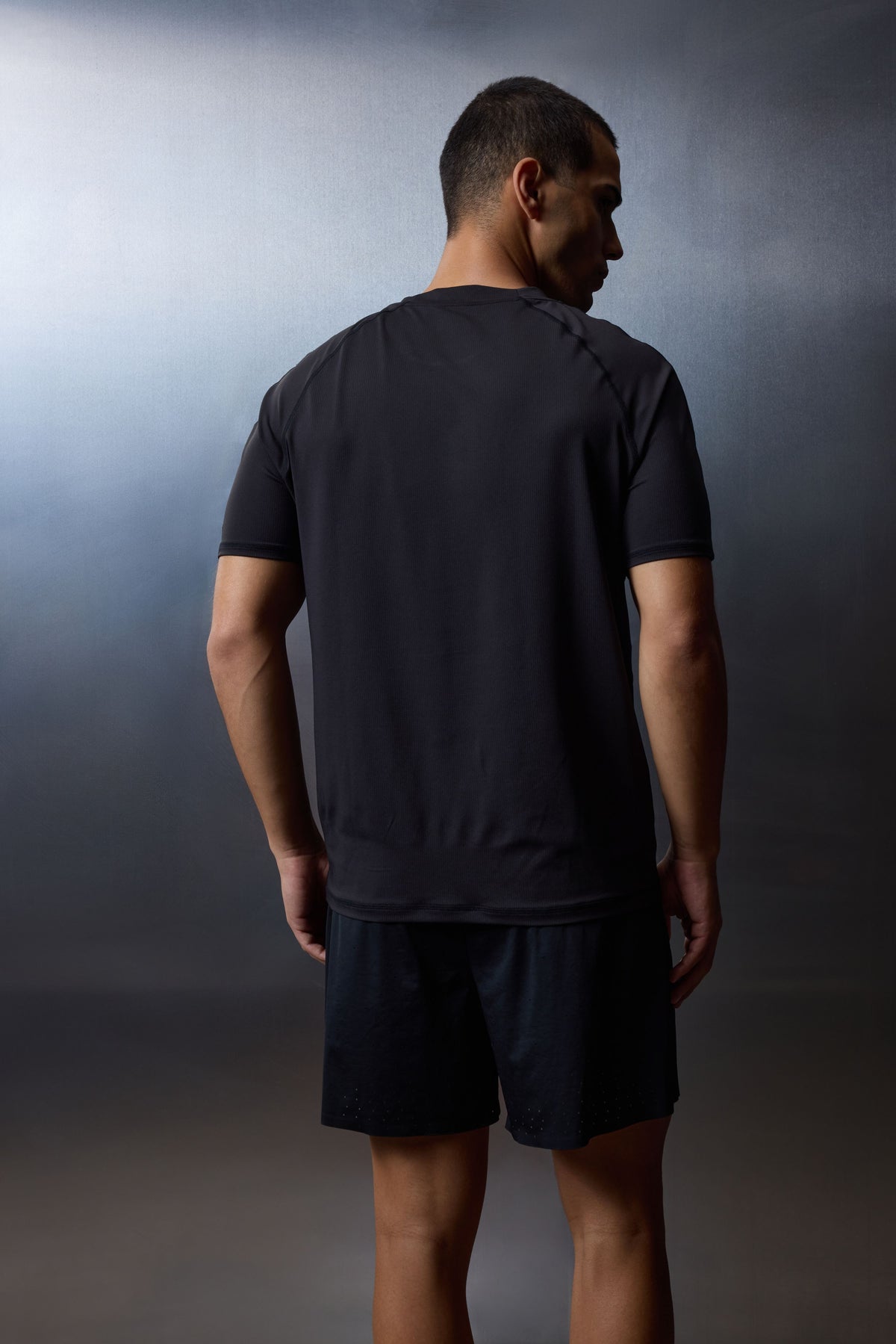 Men's Short Sleeved Training Top in Black – model side view