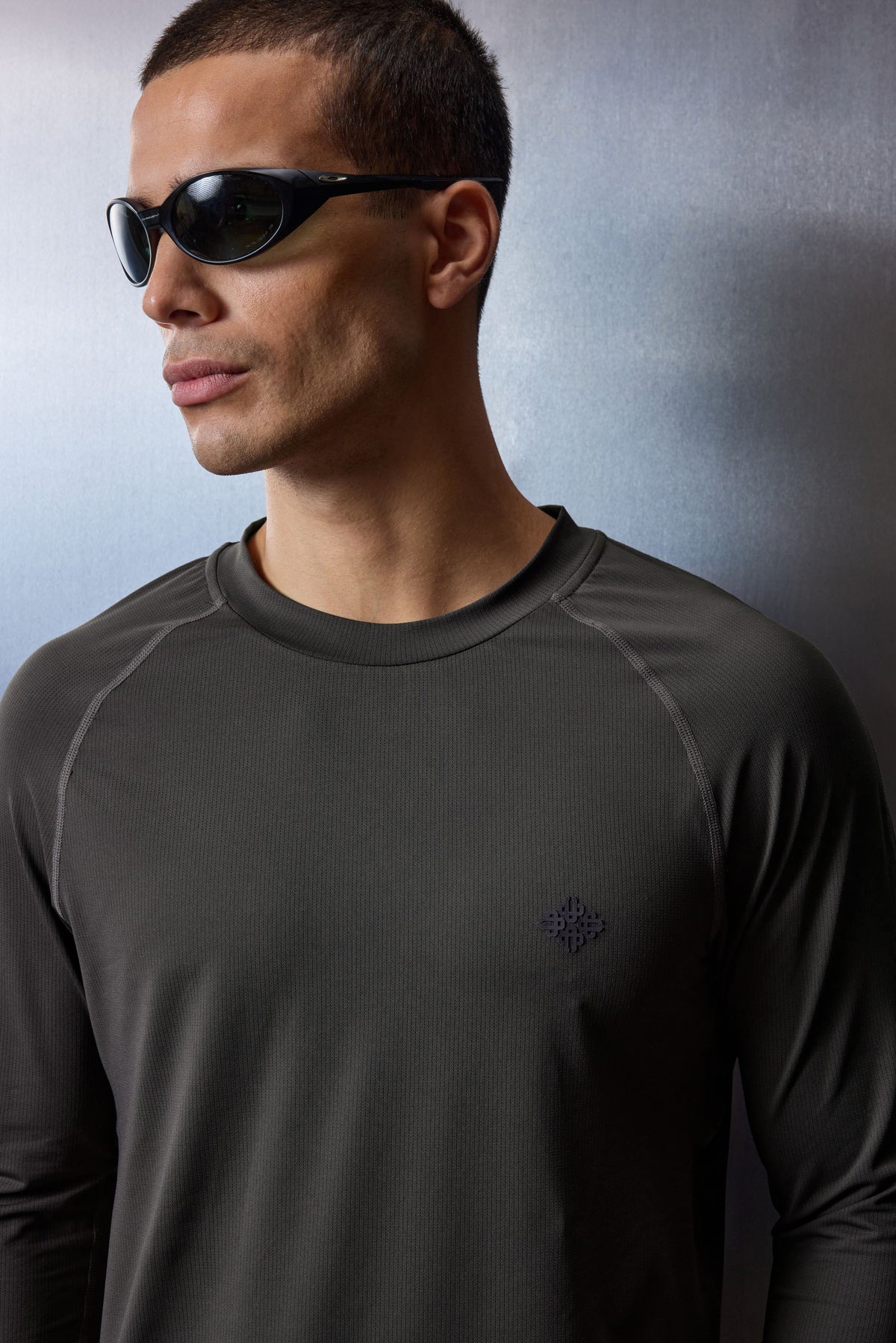 Men's Long Sleeve Training Top in Charcoal – close-up of model wearing sunglasses