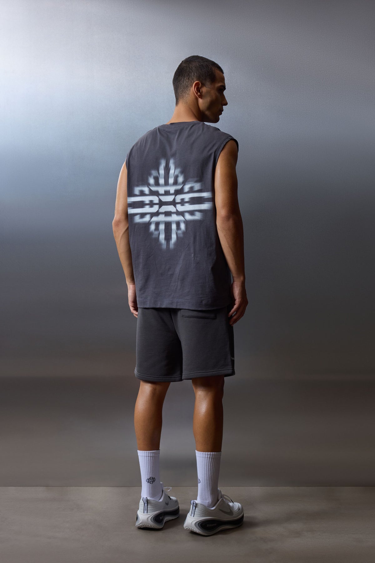 Men's Luxury In Motion Graphic Cut Off Vest in Charcoal – full-length model back view