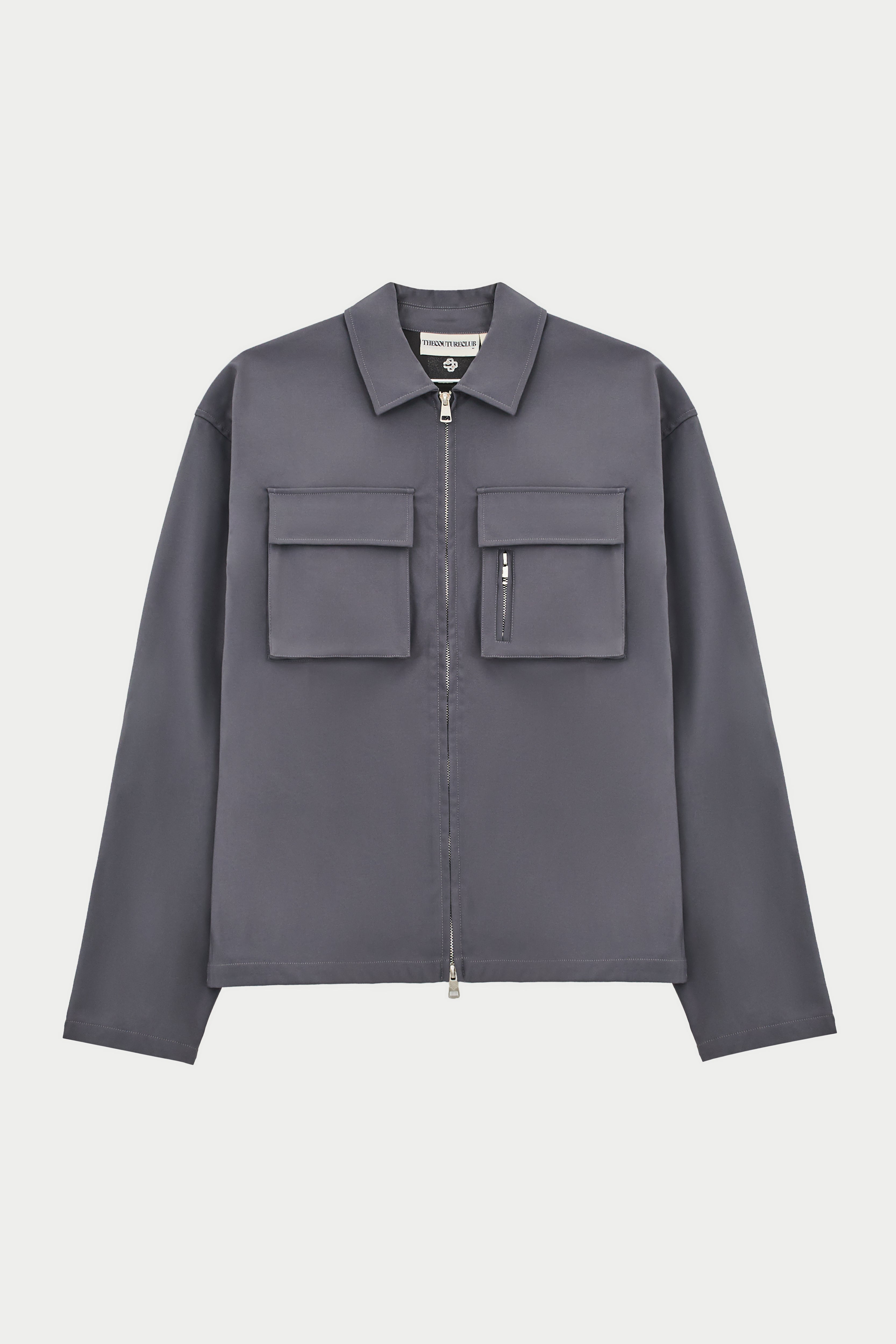 A long sleeve grey shirt with collar, chest cargo pockets, and a central zip fastening.