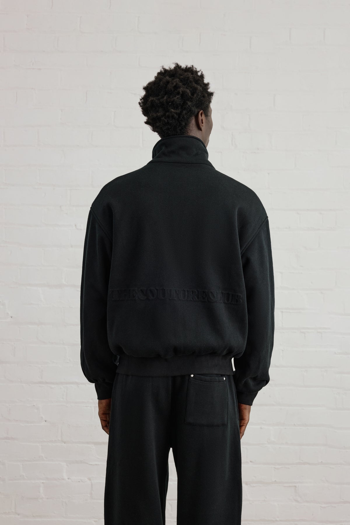 KNIT FLEECEBACK COPYRIGHT FUNNEL NECK - BLACK