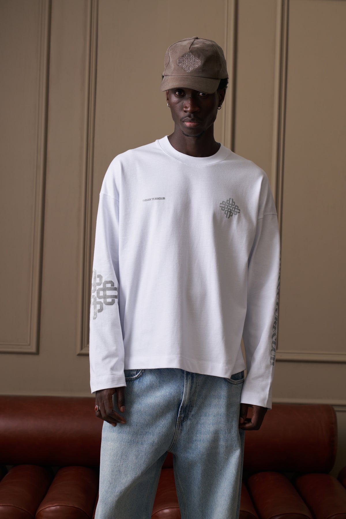 Men's Vintage Copyright Print Long Sleeve T-Shirt in White Charcoal – model front view styled with light wash jeans