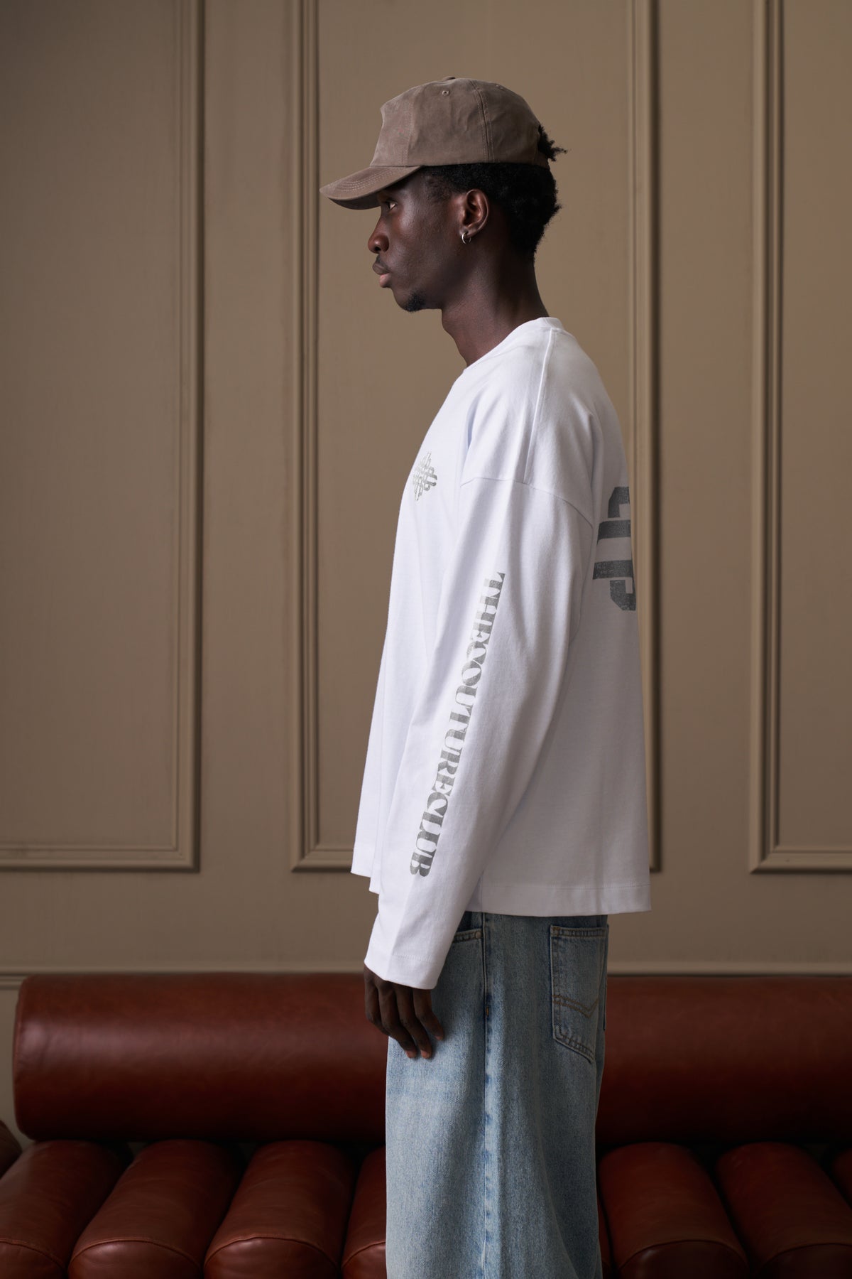 Men's Vintage Copyright Print Long Sleeve T-Shirt in White Charcoal – model side view showing the sleeve text print