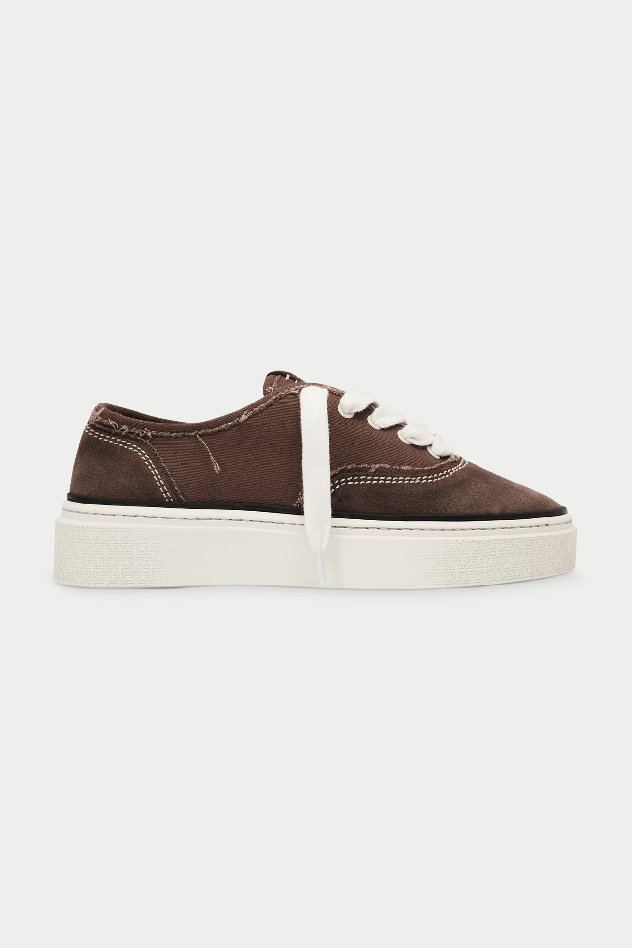Brown sneaker with white sole on a white background