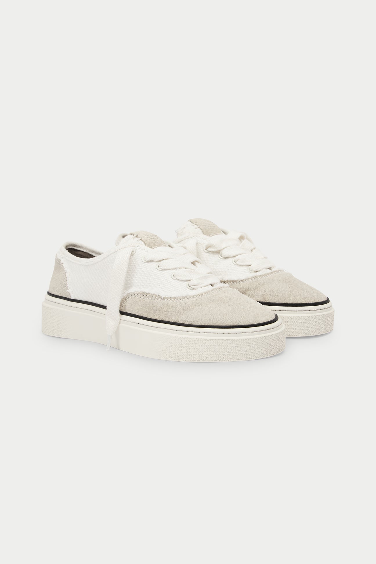 Pair of white and beige sneakers and black accents on a white background.