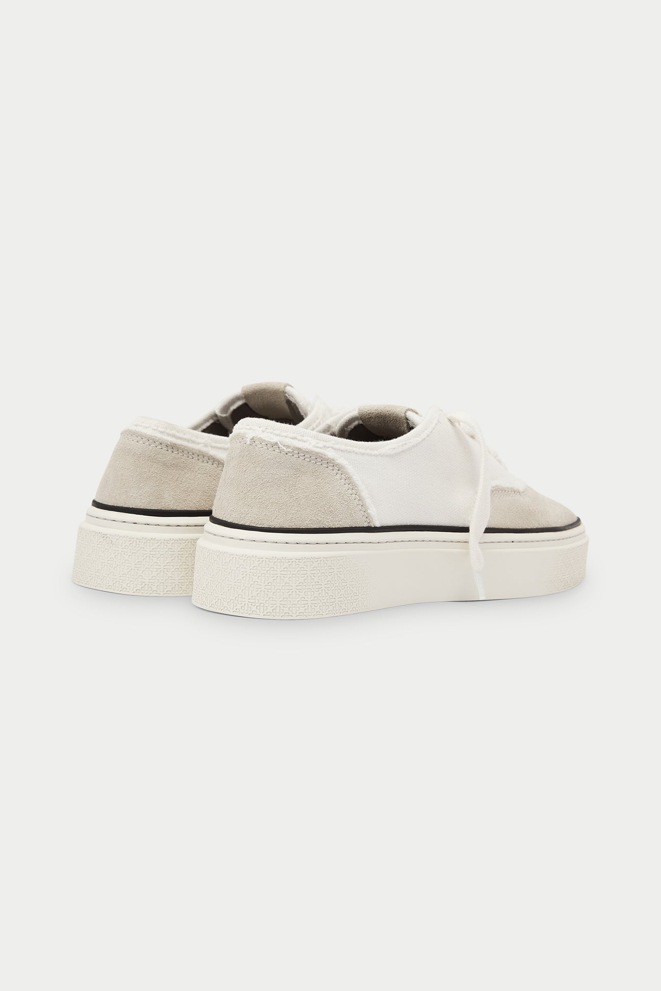 Pair of white and beige sneakers and black accents on a white background.
