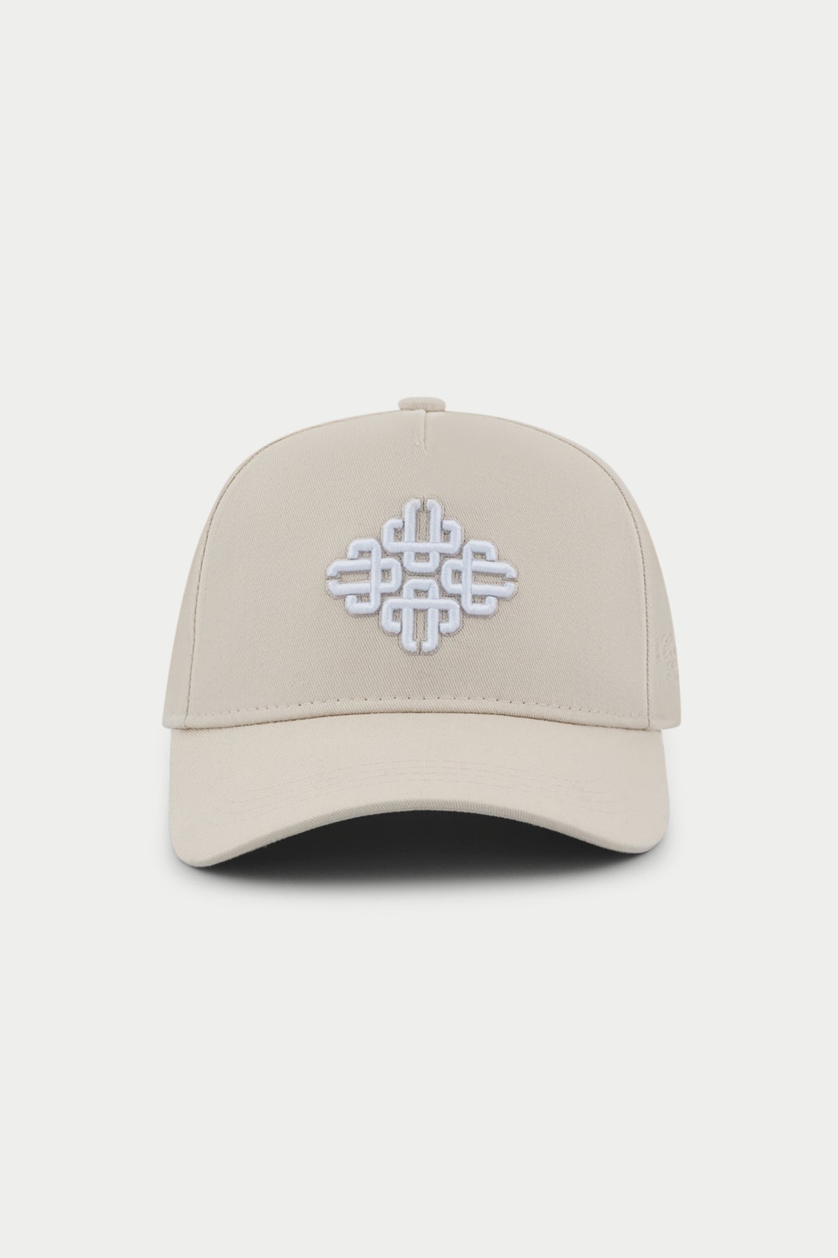 Beige cap with a white embroidered emblem logo on a white background
