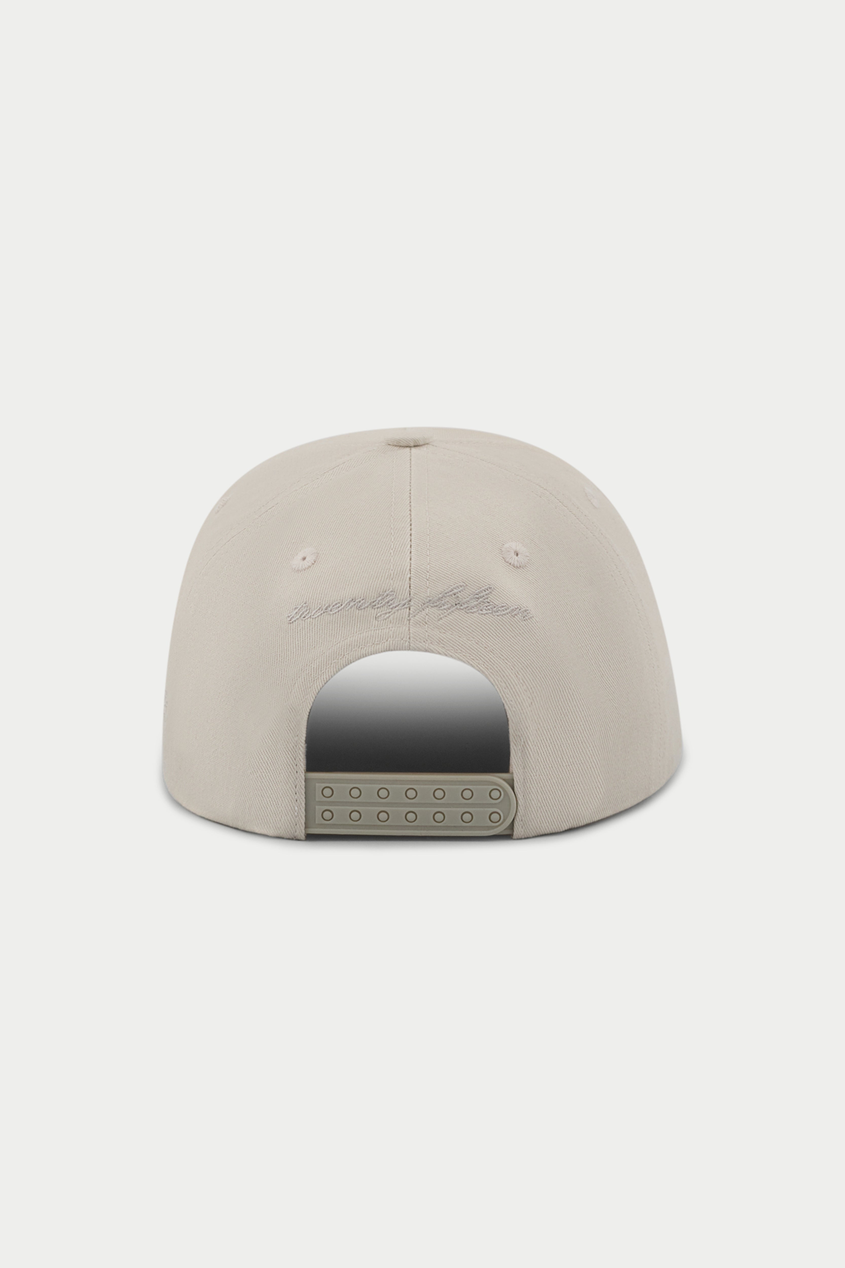 Beige cap with a white embroidered emblem logo on a white background