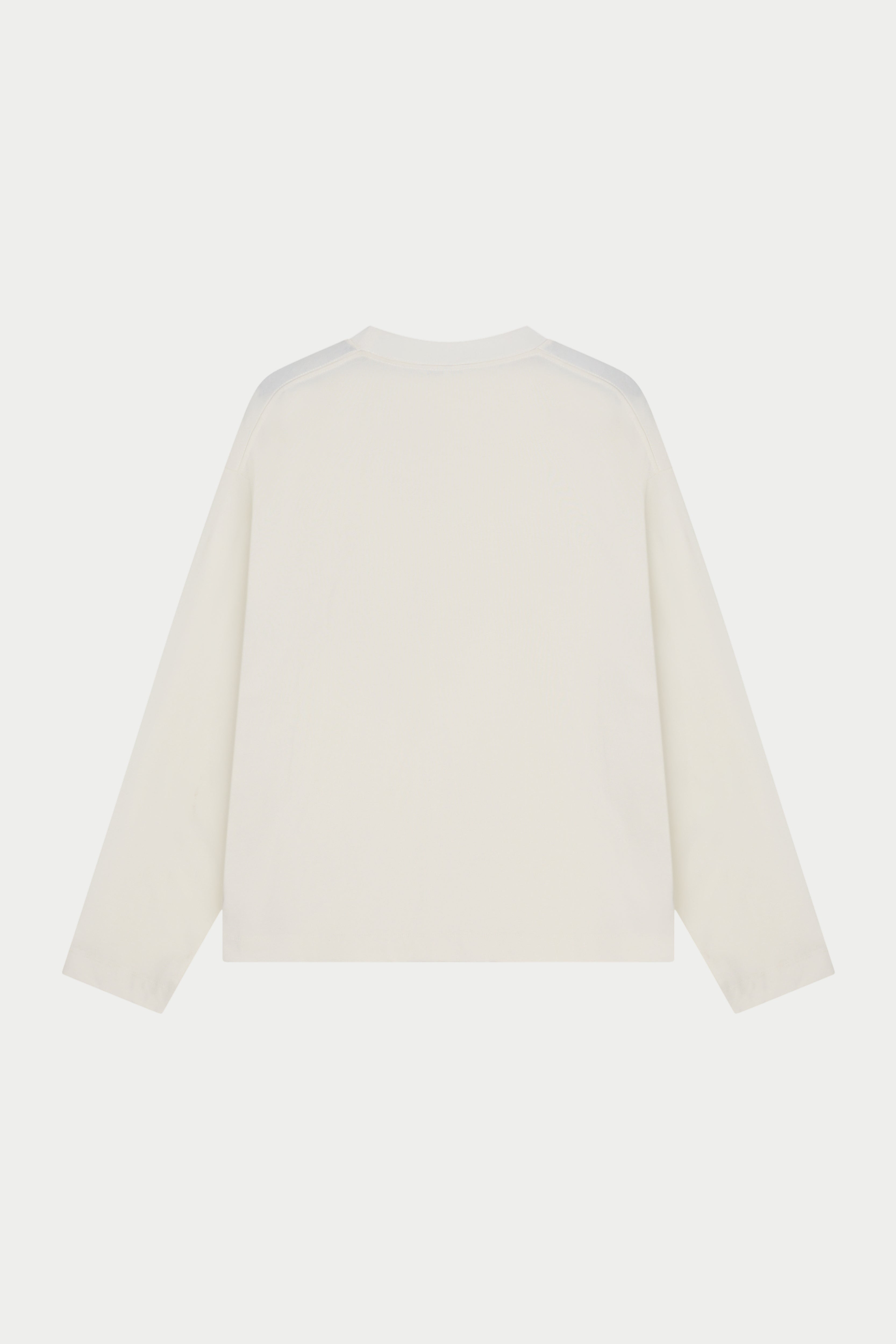 A long sleeved off white t-shirt against a white background