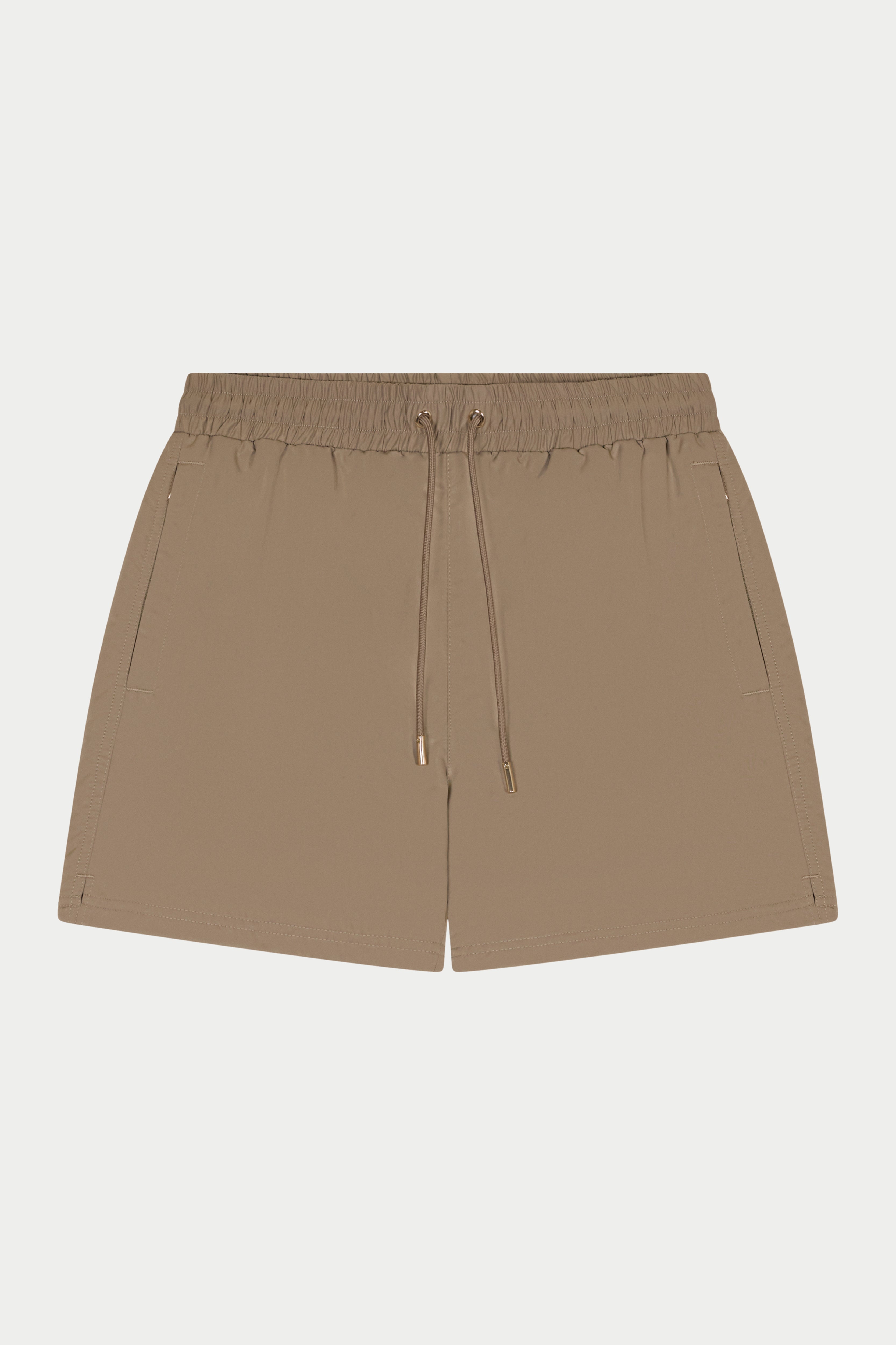 Beige shorts with a drawstring on a light gray background