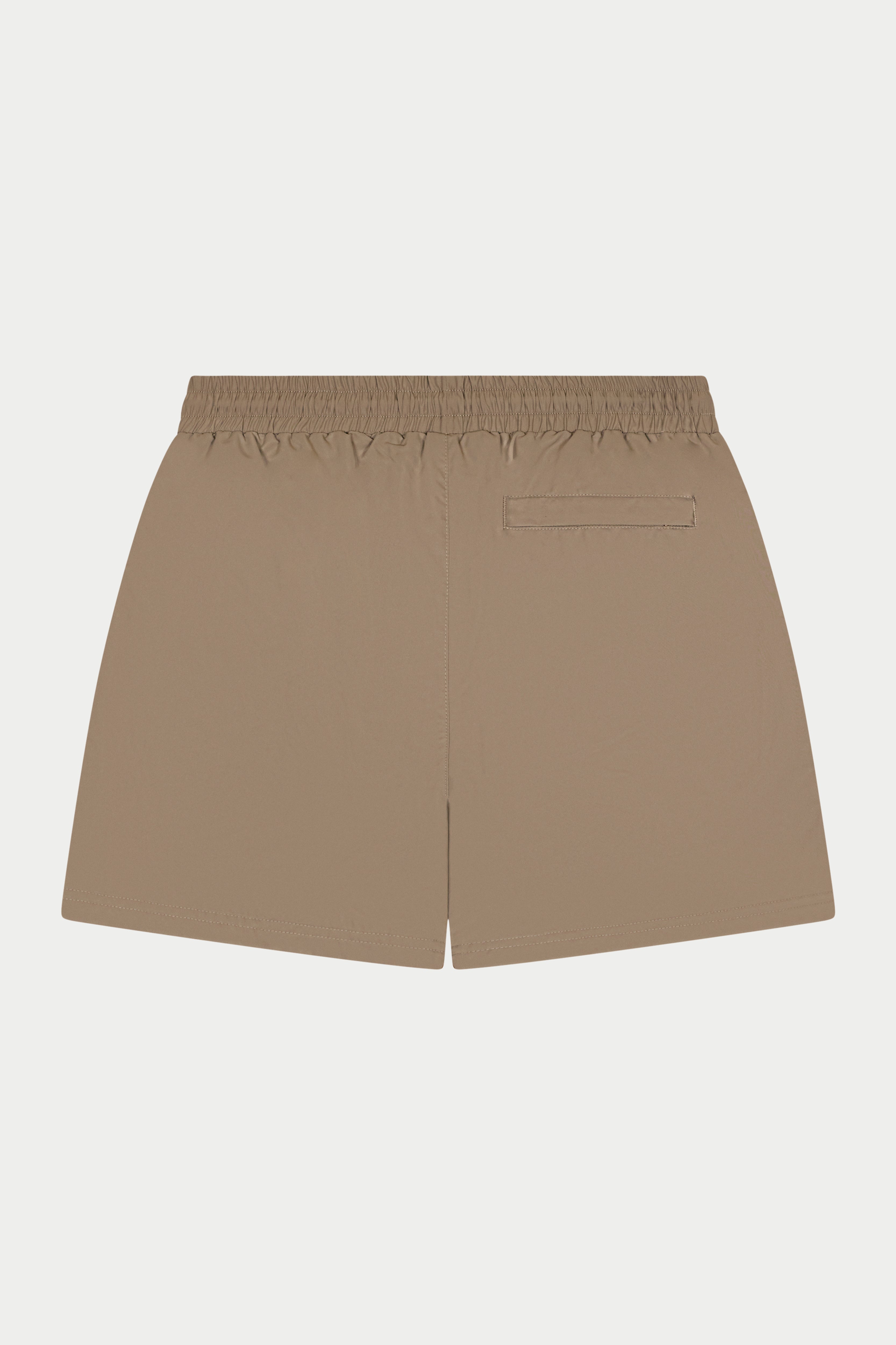 Beige shorts on a light gray background