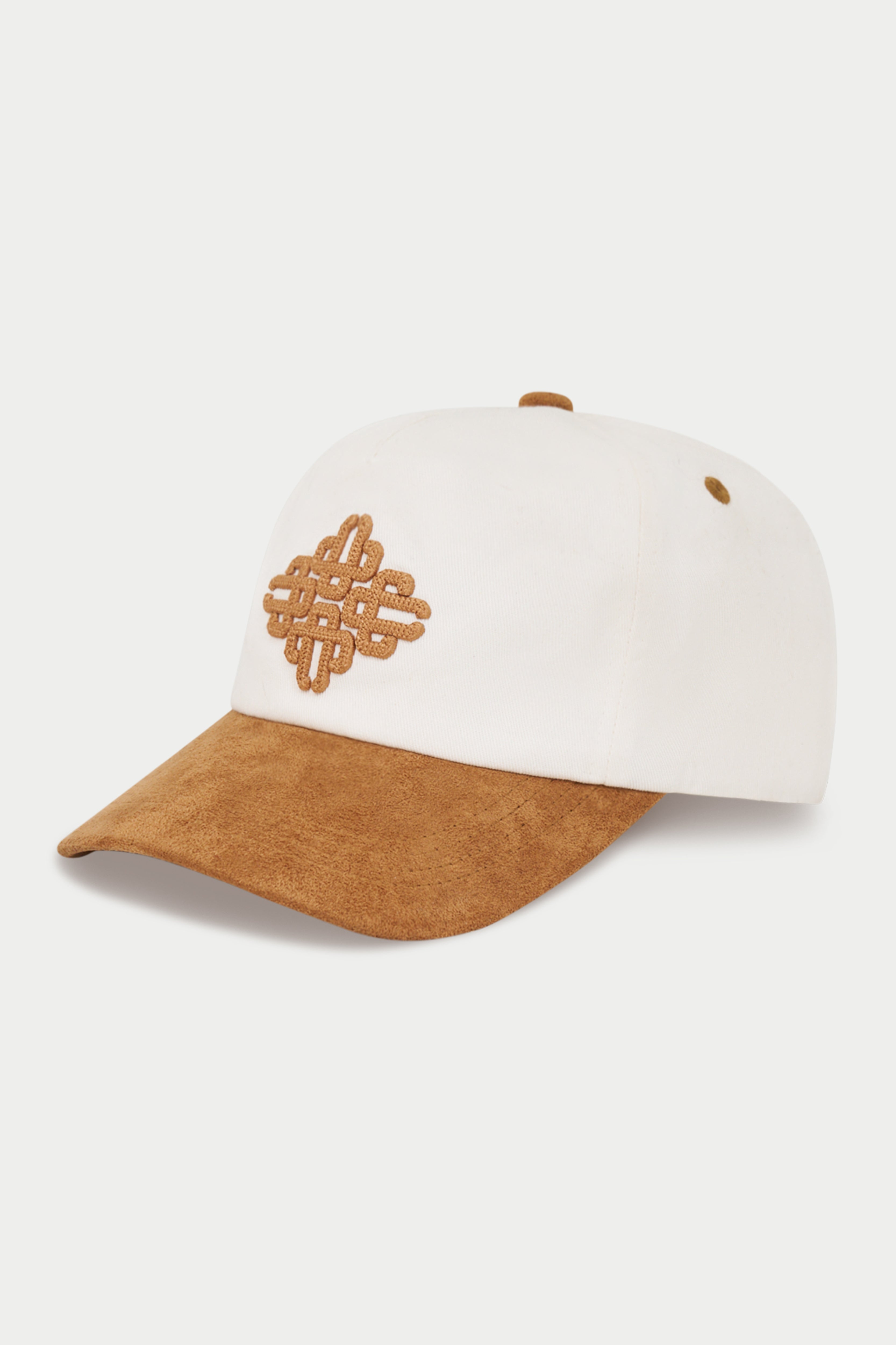 A baseball cap with a white crown and a brown suede-look curved brim, featuring a matching brown embroidered knot motif on the front.