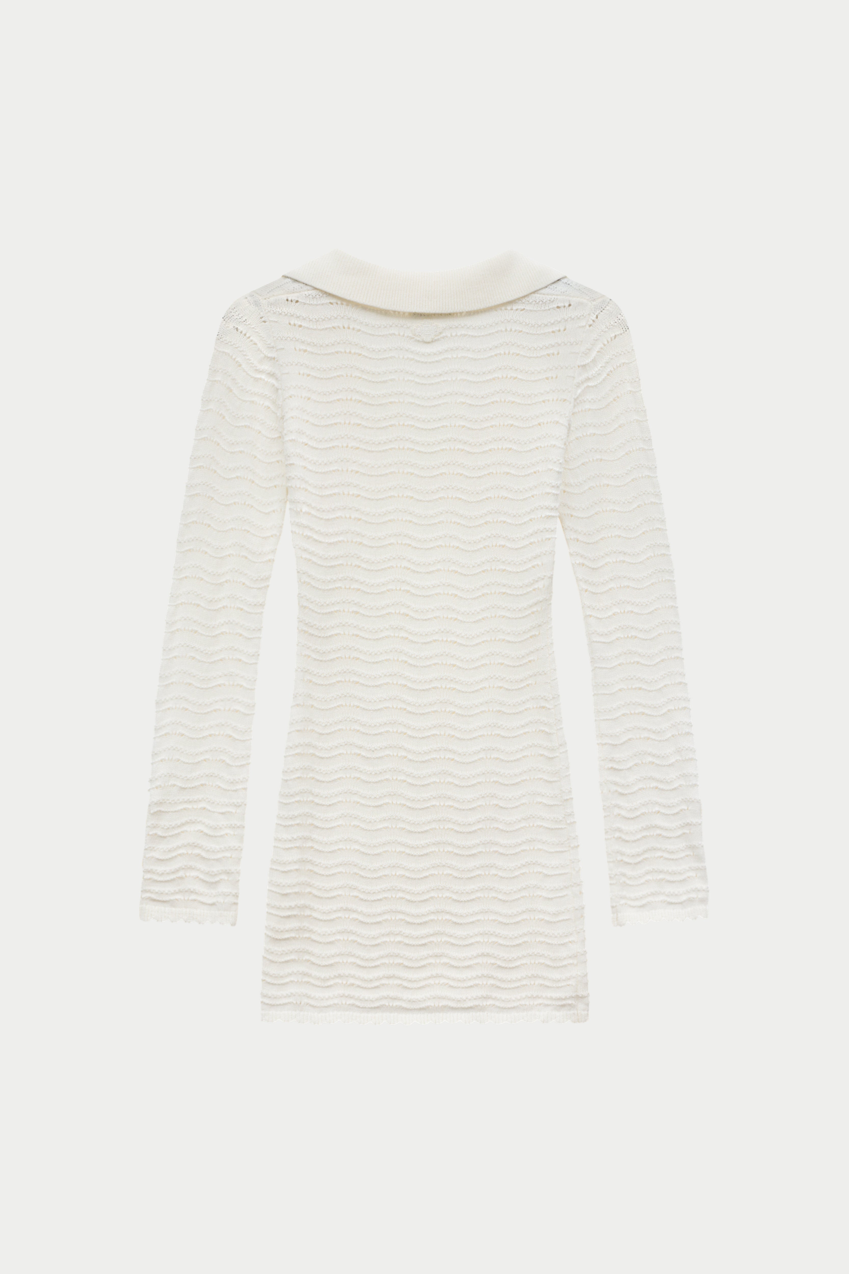 White crochet knitted long-sleeve dress on a white background