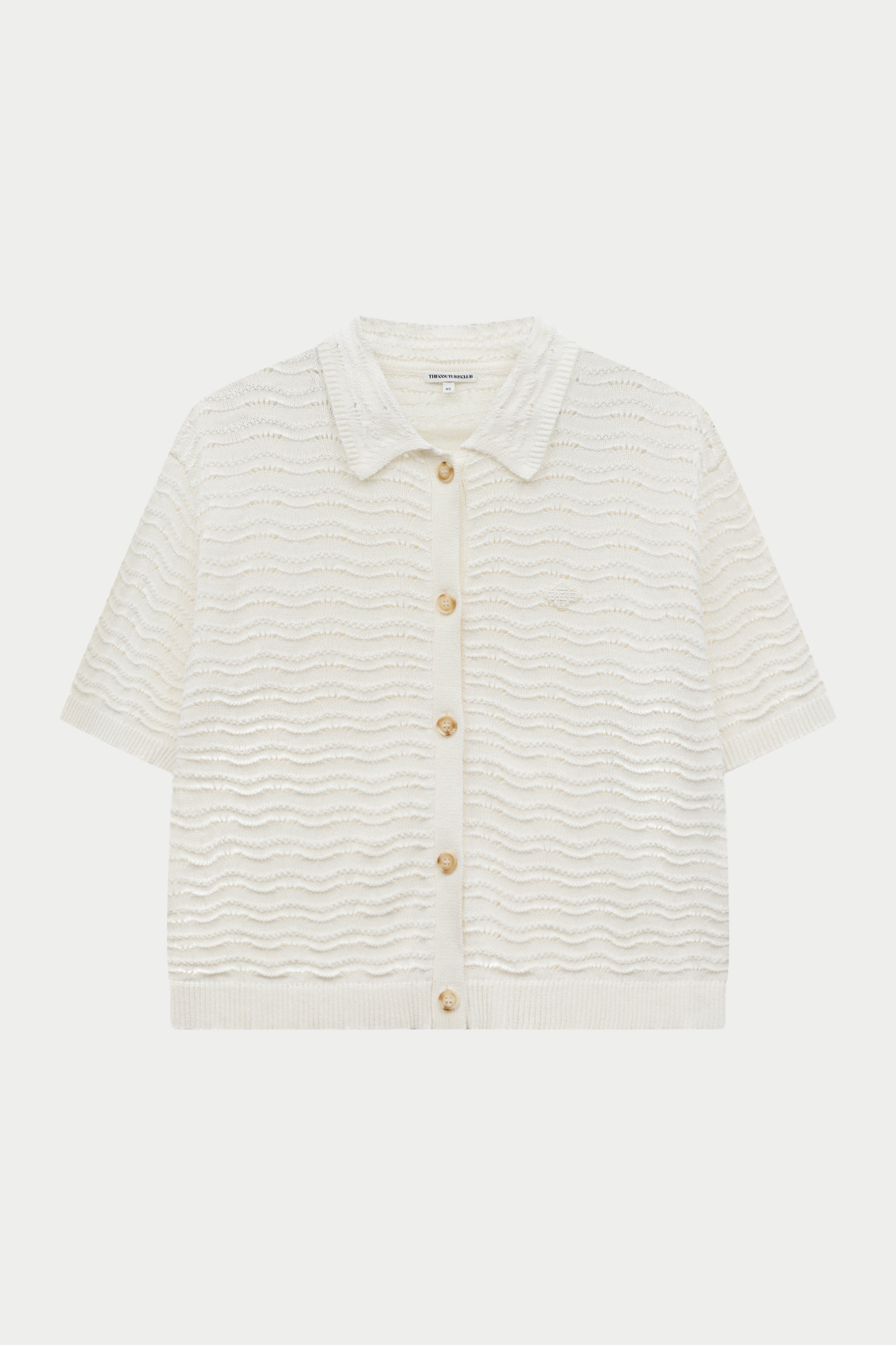 Off white crochet crochet knit shirt on a white background.