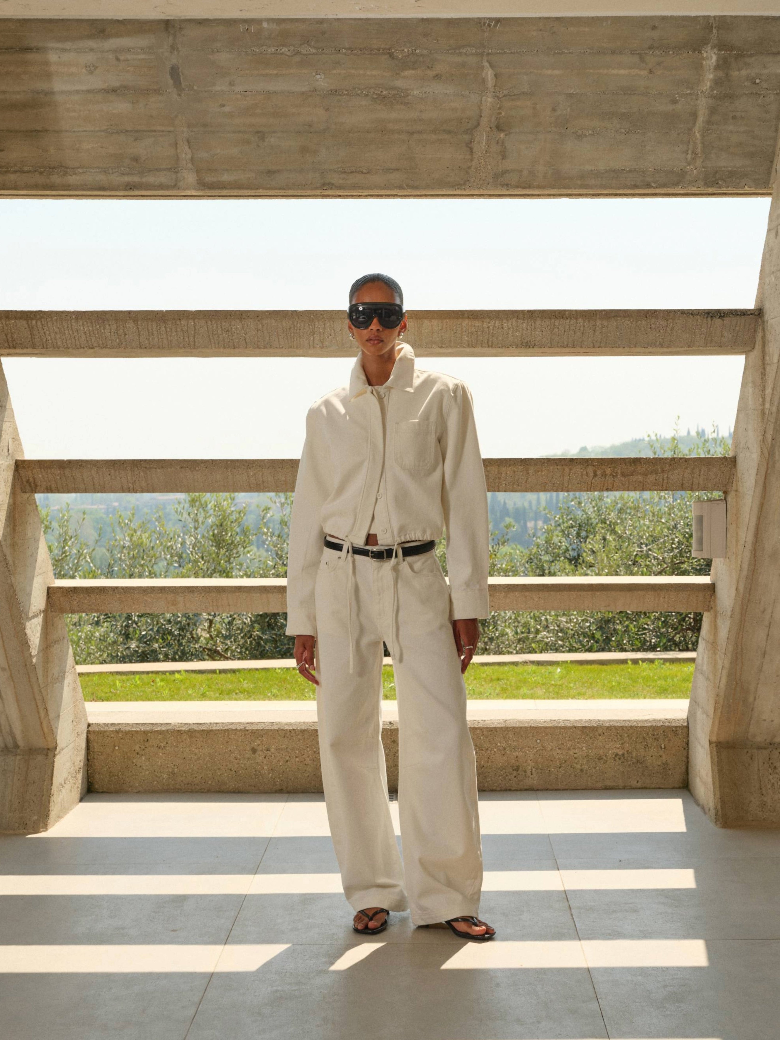 Person wearing a white outfit with sunglasses