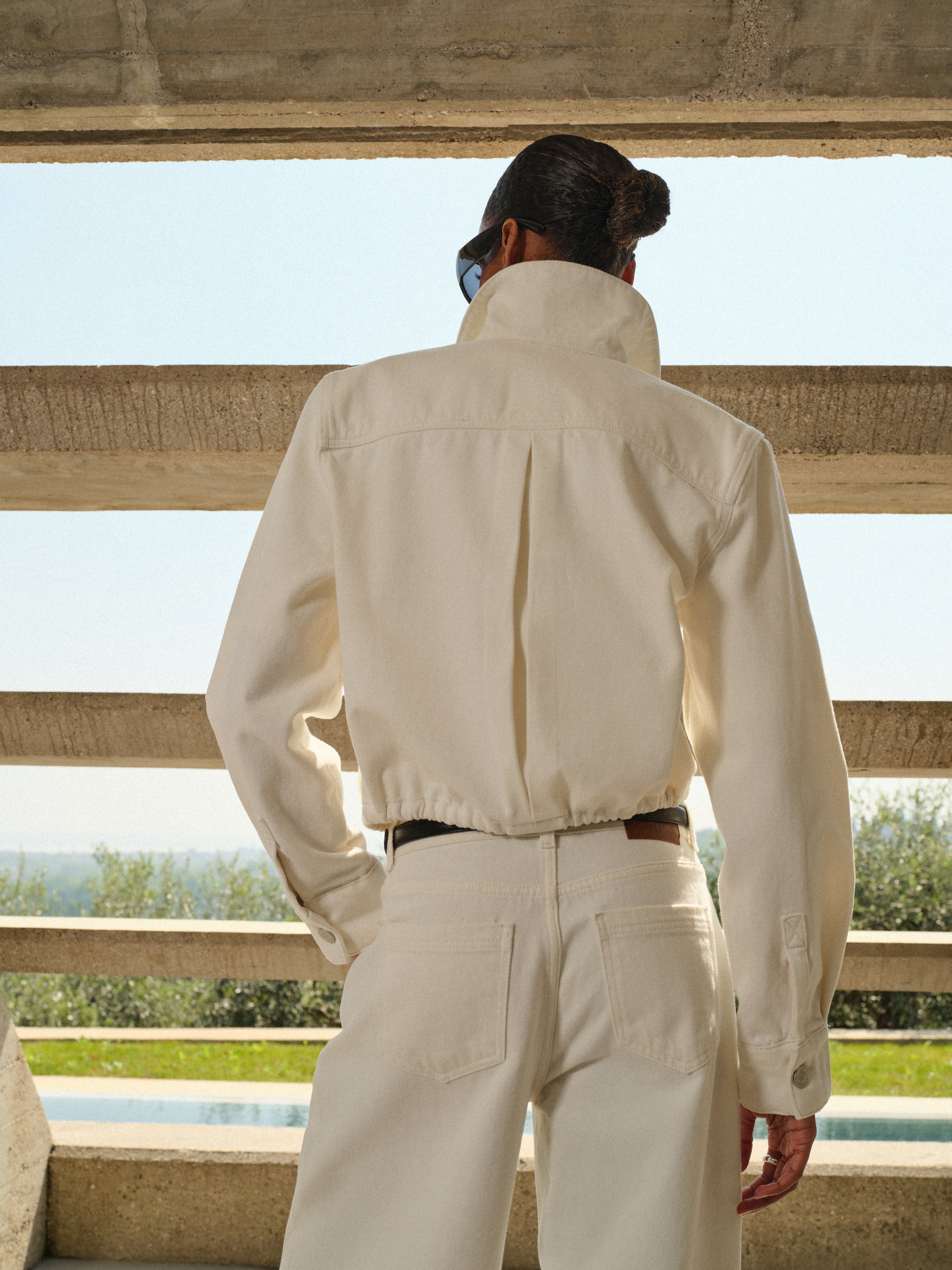 Person wearing a beige jacket and pants.