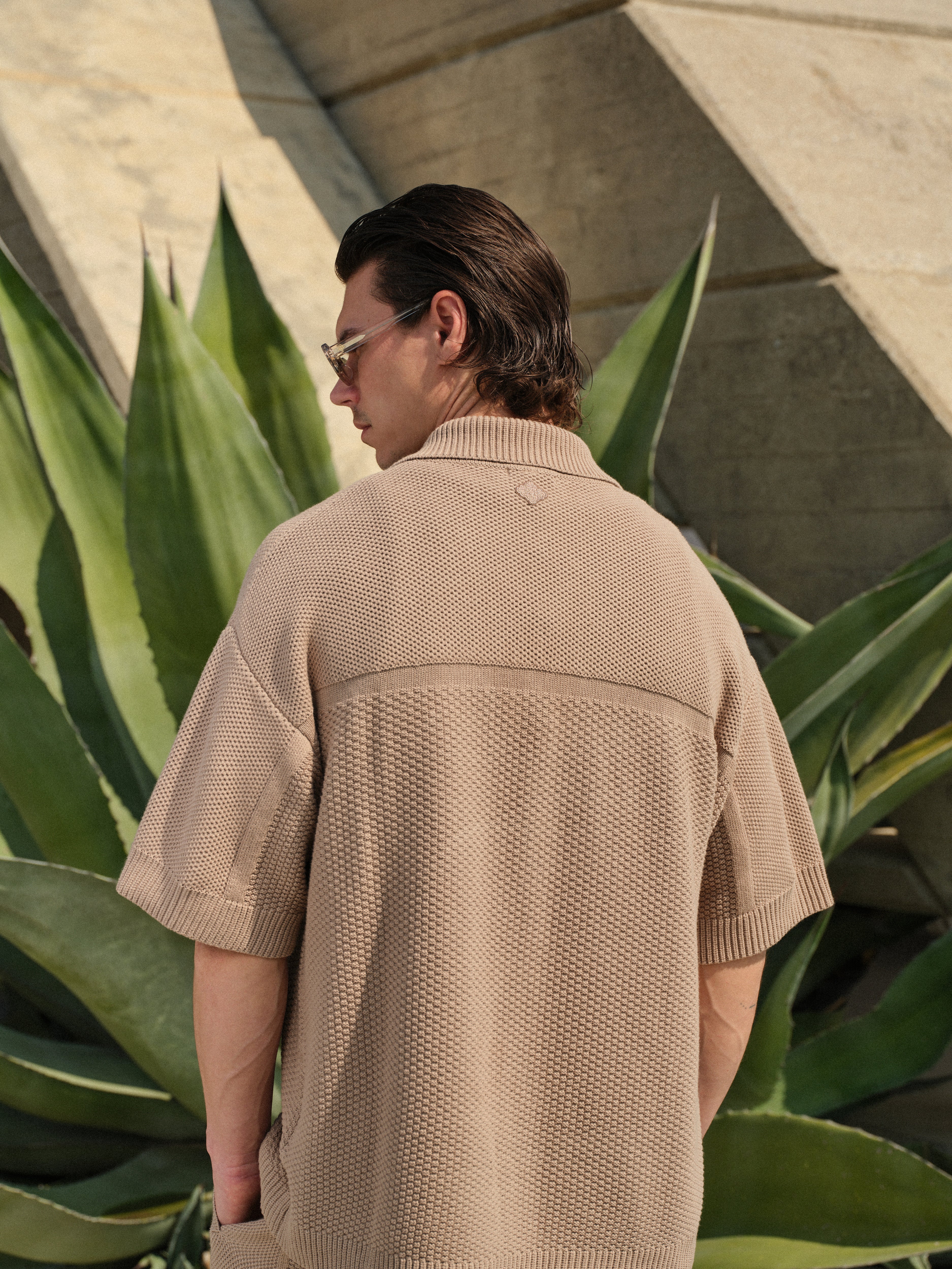 Person wearing a beige textured shirt