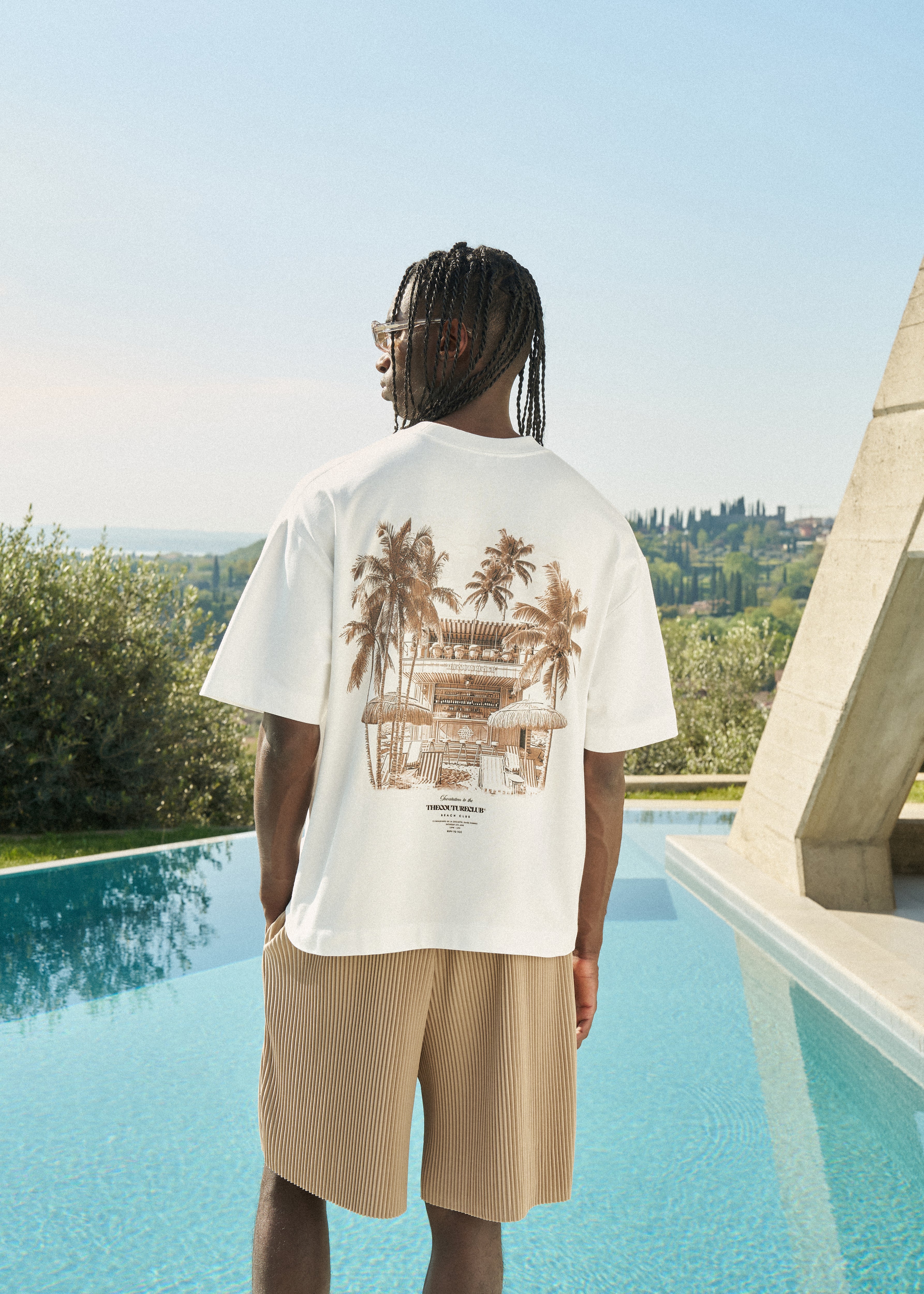Person wearing a white t-shirt with a graphic design on the back