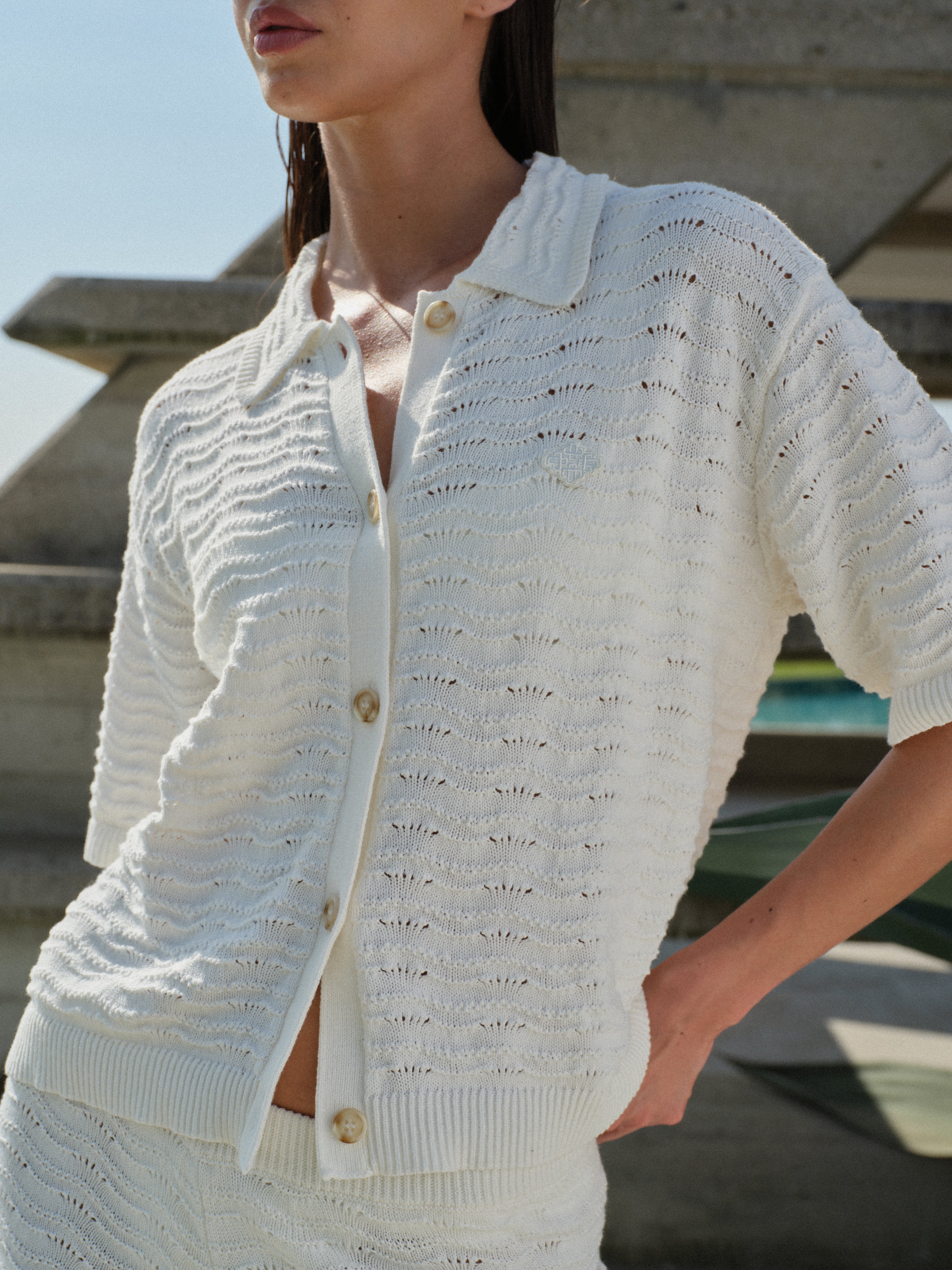 Woman in a white knit crochet shirt