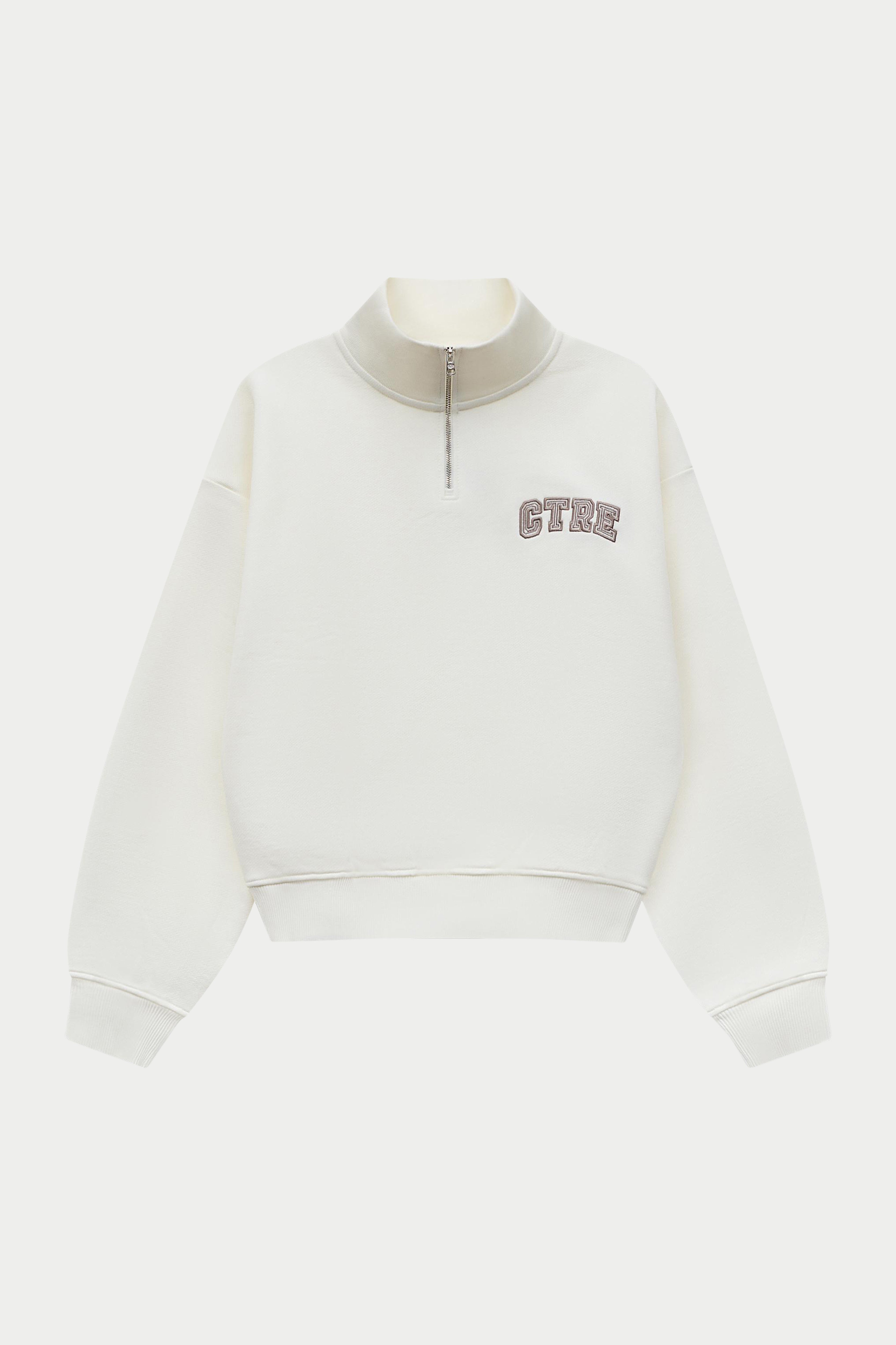 Off white quarter zip sweatshirt on a white background